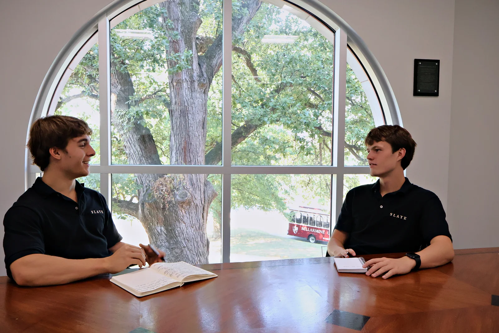 Jack Moutardier and Daxton Noe going over a client plan at the conference table